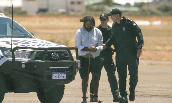 Terence Darrell Kelly boards a plane after being taken into custody by members of the Special Operations Group at Carnarvon airport in Carnarvon, Australia, on Nov. 5, 2021. (Tamati Smith/Getty Images)