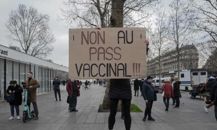 Demonstrator holds a placard that reads 'No to vaccine pass' during a rally in Paris, on Jan. 22, 2022. (Rafael Yaghobzadeh/AP Photo)