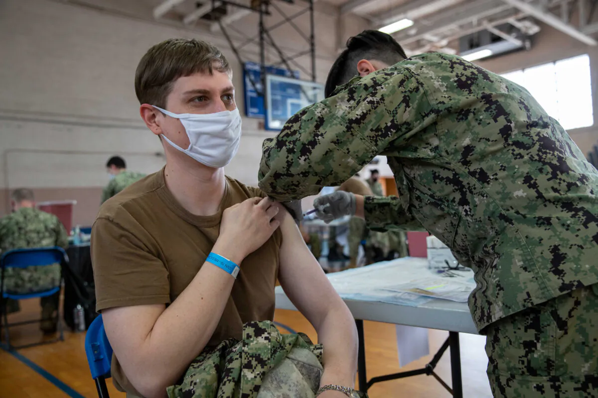 A Navy member receives a COVID-19 vaccine at the McCormick Gym onboard Naval Station Norfolk in Norfolk, Va., on April 8, 2021. (Mass Communication Specialist Seaman Jackson Adkins/U.S. Navy)