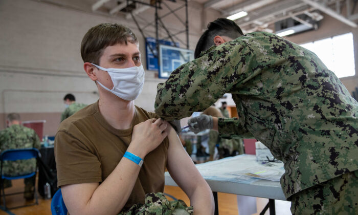 A Navy member receives a COVID-19 vaccine at the McCormick Gym onboard Naval Station Norfolk in Norfolk, Va., on April 8, 2021. (Mass Communication Specialist Seaman Jackson Adkins/U.S. Navy)