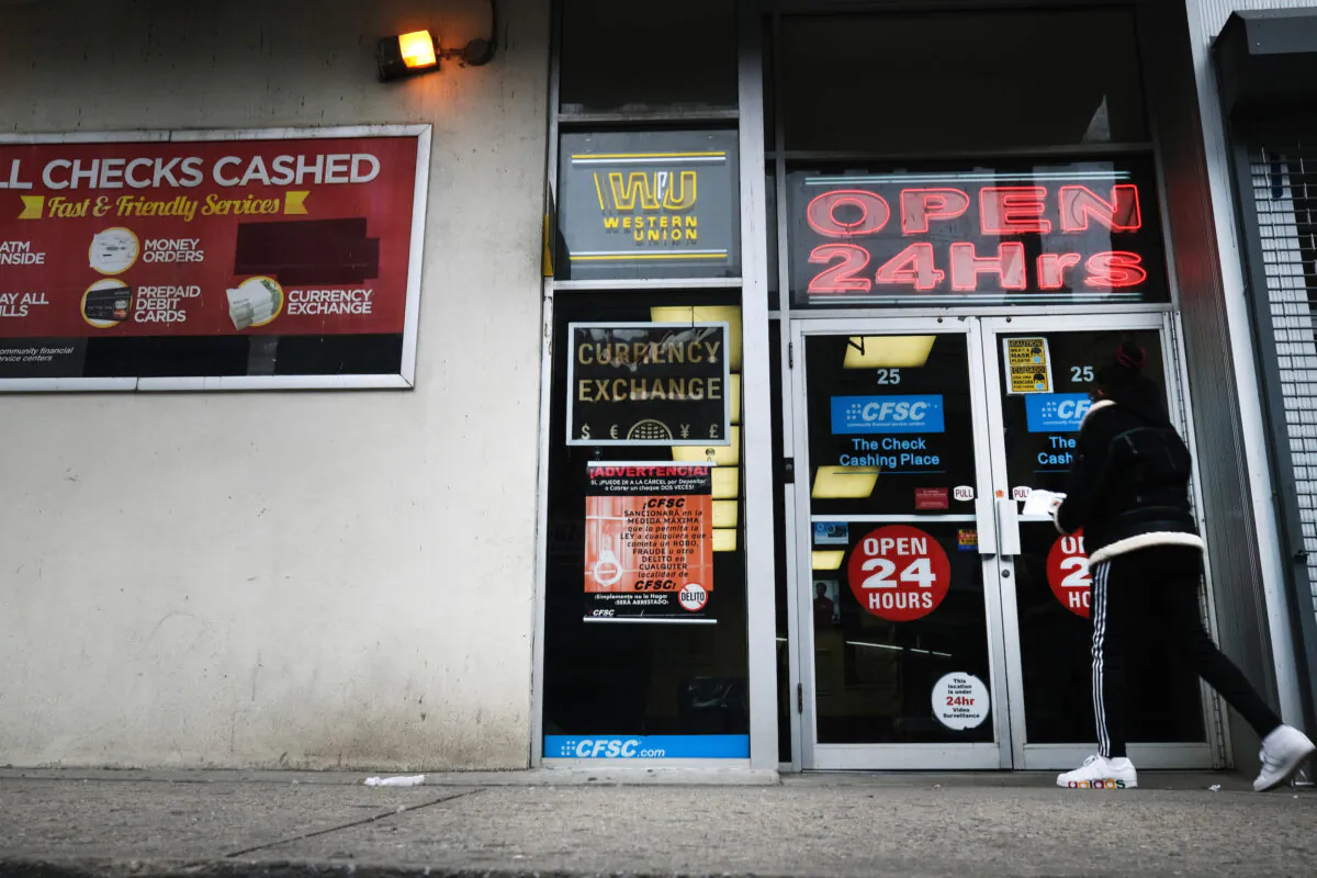 People walk into a check cashing store in downtown Brooklyn in New York on Jan. 8, 2021. (Spencer Platt/Getty Images)