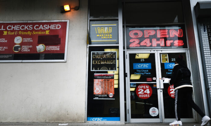 People walk into a check cashing store in downtown Brooklyn in New York on Jan. 8, 2021. (Spencer Platt/Getty Images)