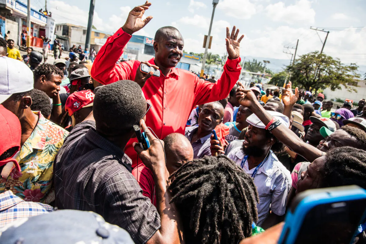 Chairman of the Pitit Desalin political party Jean-Charles Moïse (C) speaks during the protest demanding the resignation of President Jovenel Moïse in Port-au-Prince on Oct. 17, 2019. (Valerie Baeriswyl/ AFP via Getty Images)