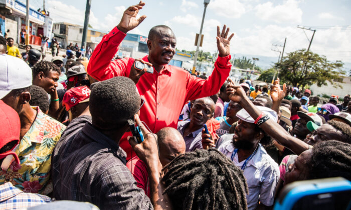 Chairman of the Pitit Desalin political party Jean-Charles Moïse (C) speaks during the protest demanding the resignation of President Jovenel Moïse in Port-au-Prince on Oct. 17, 2019. (Valerie Baeriswyl/ AFP via Getty Images)