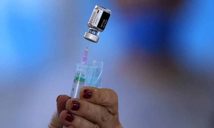 Healthcare workers will prepare a shot of the Pfizer COVID-19 vaccine at the Community Health Center in Brasília, Brazil, on January 16, 2022.  (AP / Elald Perez)