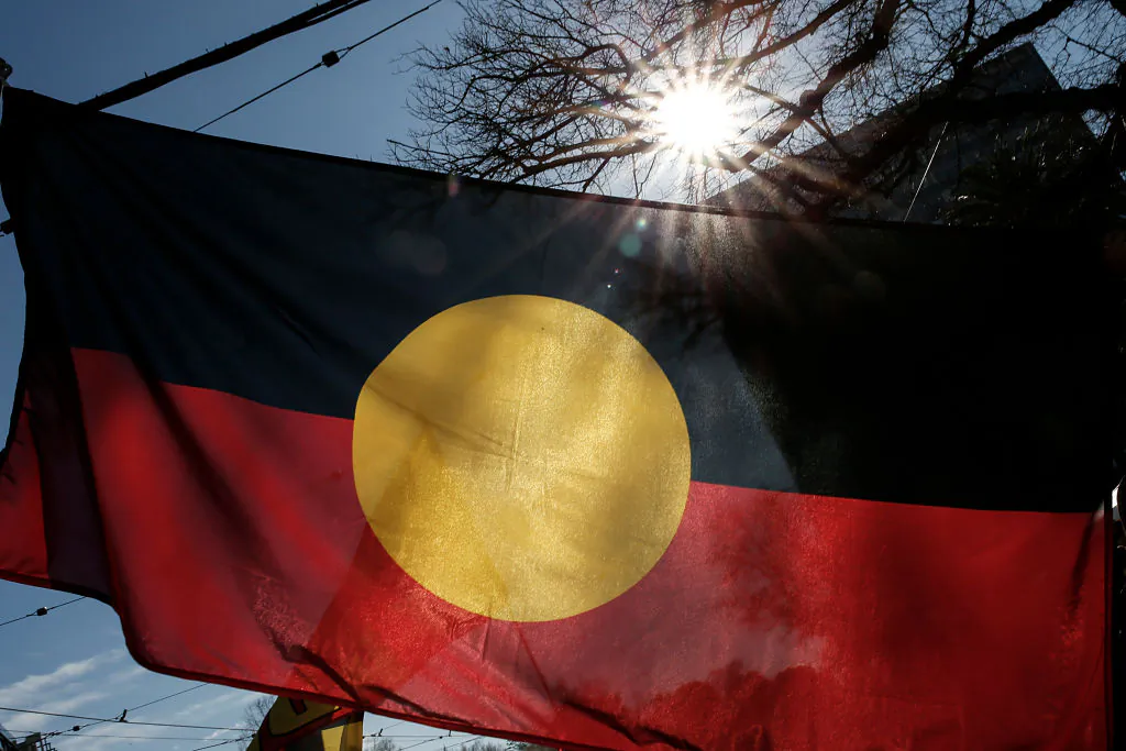 MELBOURNE, AUSTRALIA - JULY 05: The Indigenous Flag is seen flying during the NAIDOC March. Debate has begun around who owns the Indigenous Flag and who can use it under copyright law. The march marks the start of NAIDOC Week, which runs in the first full week of July each year. NAIDOC Week celebrations are held across Australia to celebrate the history, culture and achievements of Aboriginal and Torres Strait Islander peoples. NAIDOC is celebrated not only in Indigenous communities, but by Australians from all walks of life. (Photo by Darrian Traynor/Getty Images)