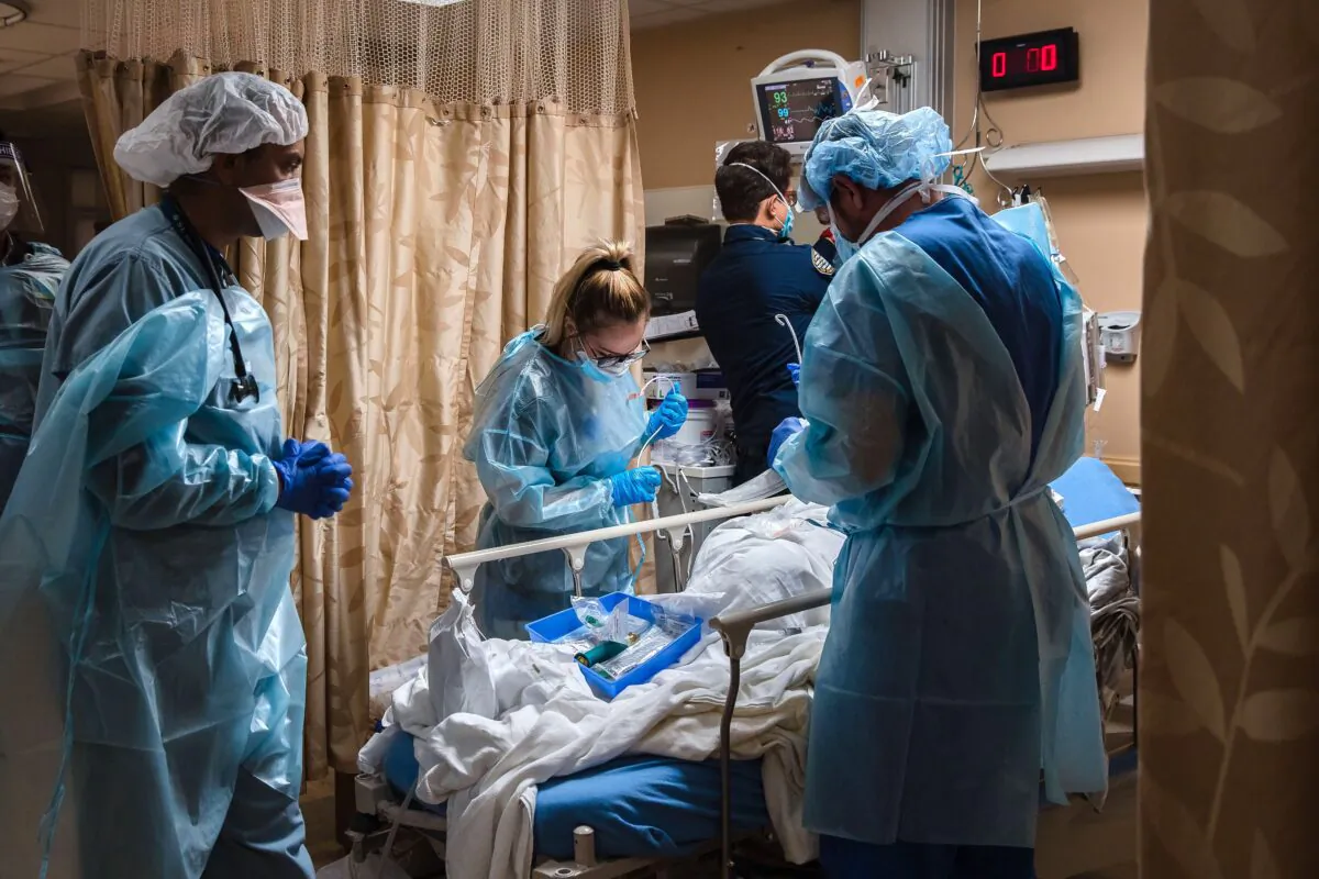 Health care workers tend to a patient with COVID-19 in Apple Valley, Calif., on Jan. 11, 2021. (Ariana Drehsler/AFP/Getty Images)