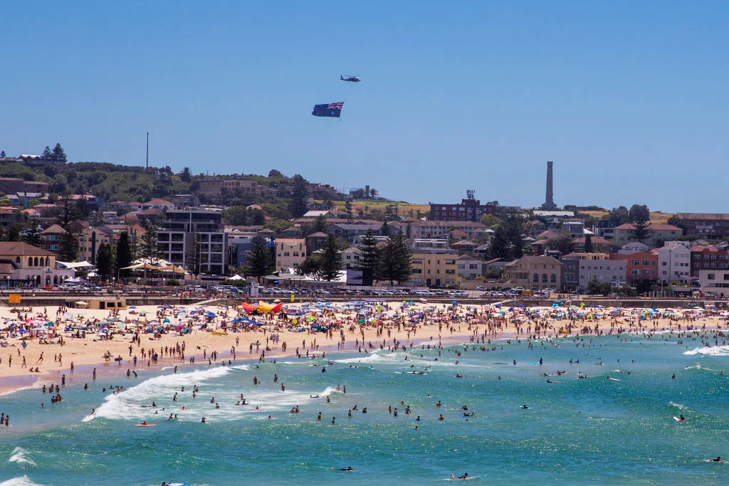 A helicopter with an Australian flag is seen over Bondi Beach in Sydney, Australia, on Jan. 26, 2021.(Jenny Evans/Getty Images)