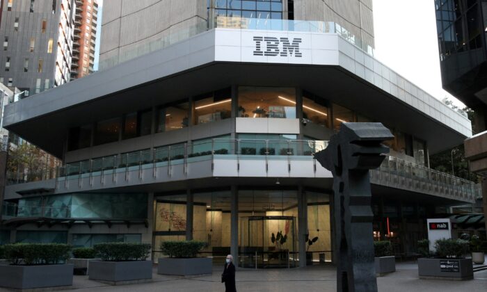 A man wearing a protective mask walks past an office building with IBM logo in the Central Business District of Sydney, on June 3, 2020. (Loren Elliott/Reuters)