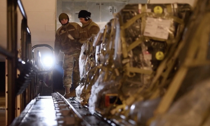U.S. Air Force personnel preparing supplies inside plane in Dover Air Force Base, Del., on Jan. 24, 2022. (Reuters/Screenshot via The Epoch Times)