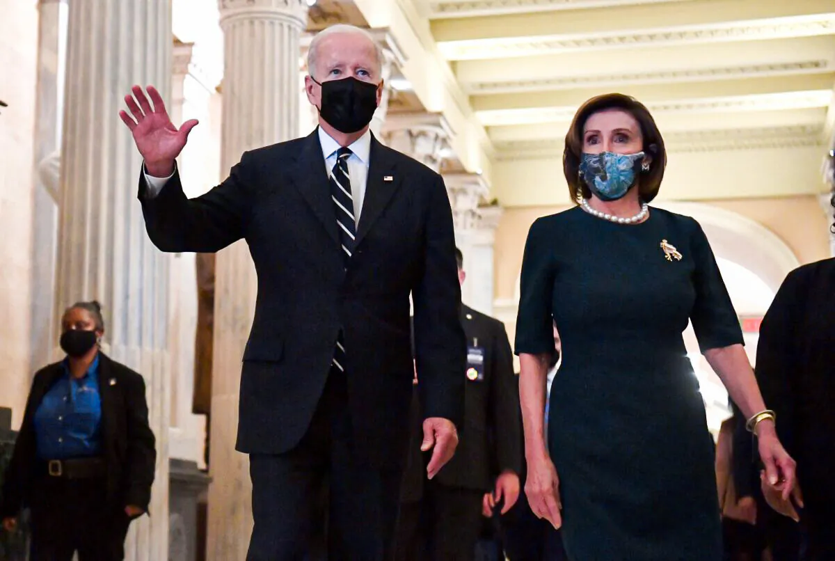 President Joe Biden and Speaker of the House Nancy Pelosi (D-Calif.) depart following a meeting with the Democratic caucus at the U.S. Capitol in Washington on Oct. 28, 2021. (Nicholas Kamm/AFP via Getty Images)