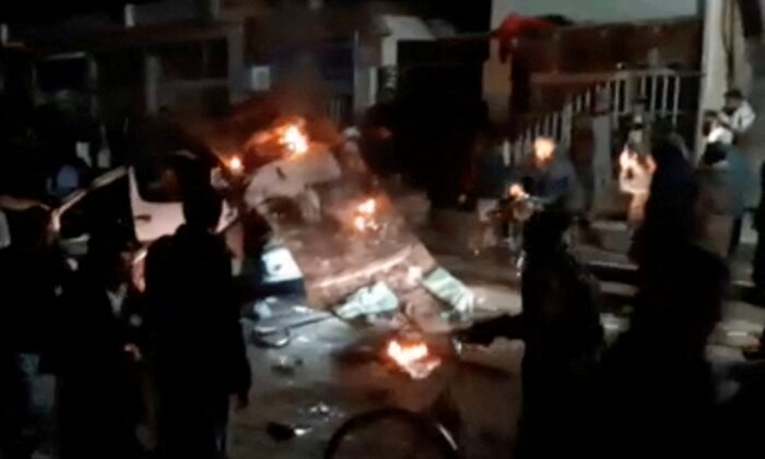 A vehicle burns in the street after a blast ripped through a minivan in the city of Herat, Afghanistan, on Jan. 22, 2022, in this screenshot taken from a video obtained by Reuters. (Reuters)