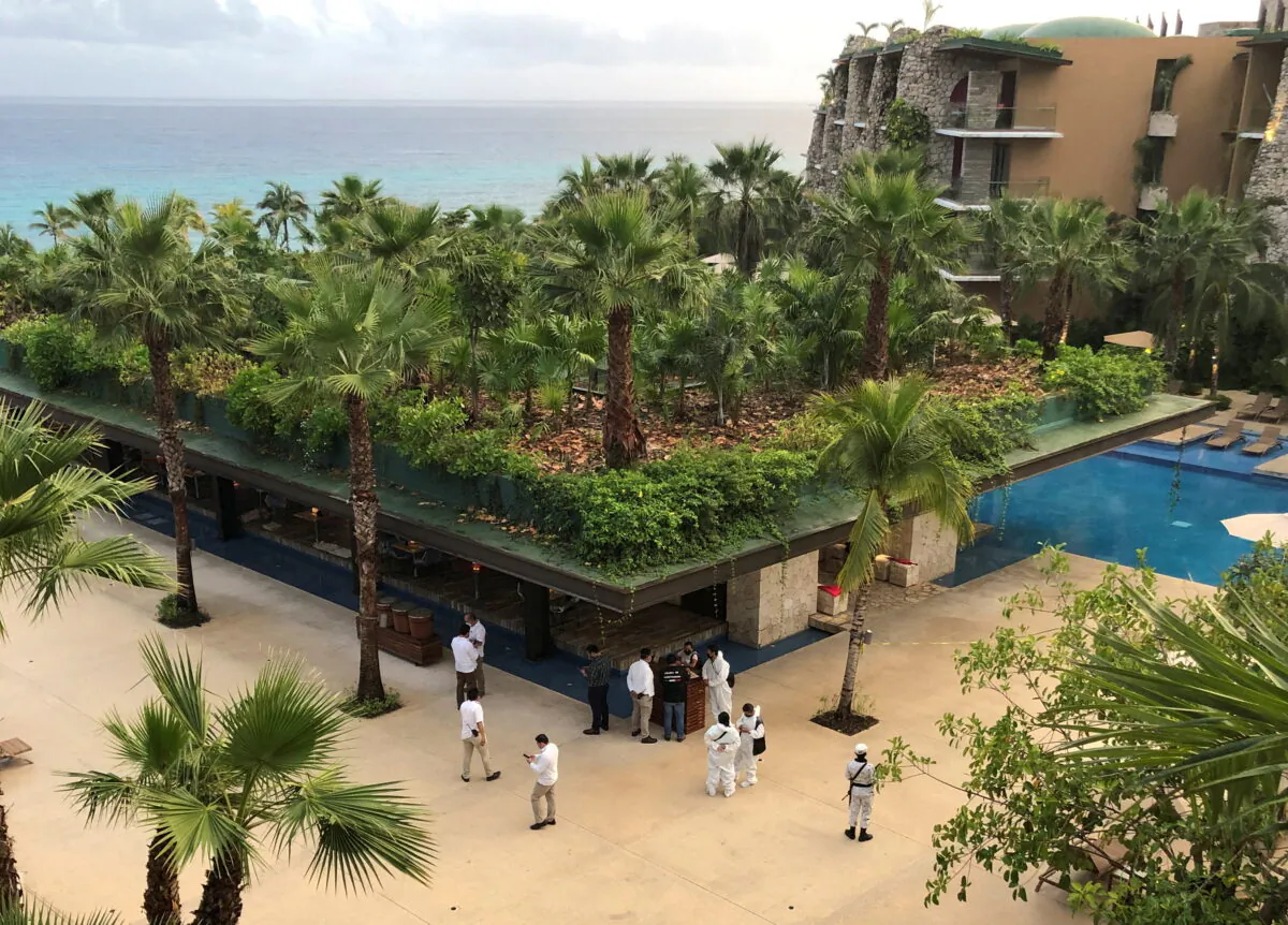 Forensic technicians and hotel employees stand near a scene where three Canadian citizens were injured by gunshots at Hotel Xcaret, in Playa del Carmen, Mexico Jan. 21, 2022. (Reuters/Stringer)