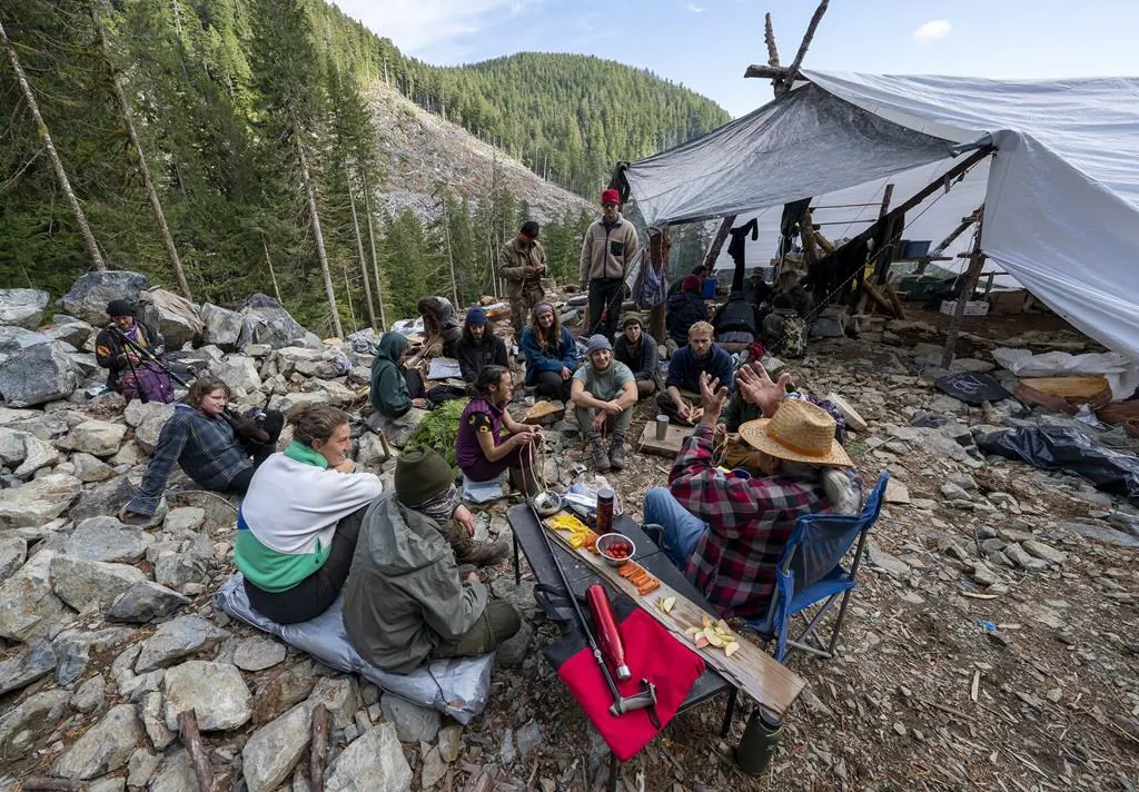 People listen to Pacheedaht elder Bill Jones in the Fairy Creek logging area near Port Renfrew, B.C., Oct. 4, 2021. (The Canadian Press/Jonathan Hayward)
