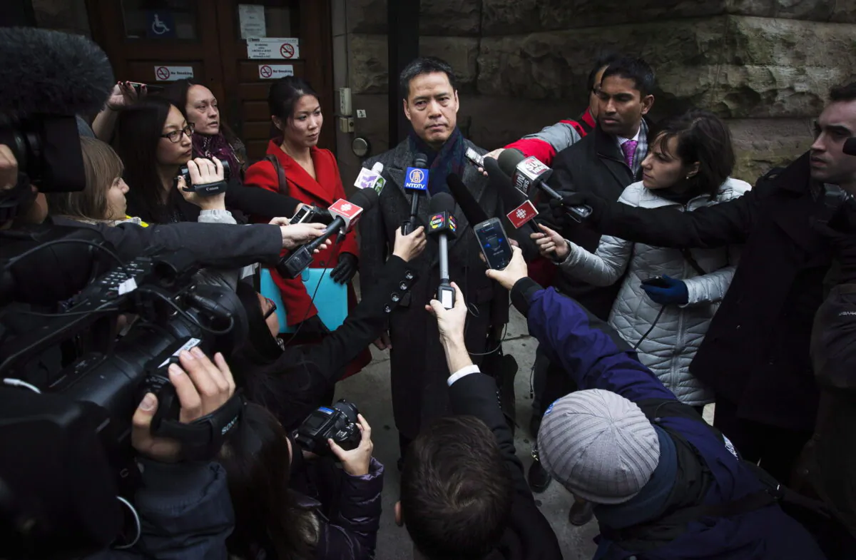 John Lee, lawyer for Qing Quentin Huang, who is accused of plotting to send sensitive information to China, speaks outside the courthouse in Toronto after Huang's bail hearing on Dec. 4, 2013. (The Canadian Press/Mark Blinch)