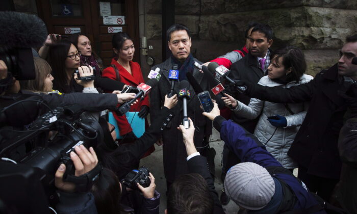 John Lee, lawyer for Qing Quentin Huang, who is accused of plotting to send sensitive information to China, speaks outside the courthouse in Toronto after Huang's bail hearing on Dec. 4, 2013. (The Canadian Press/Mark Blinch)