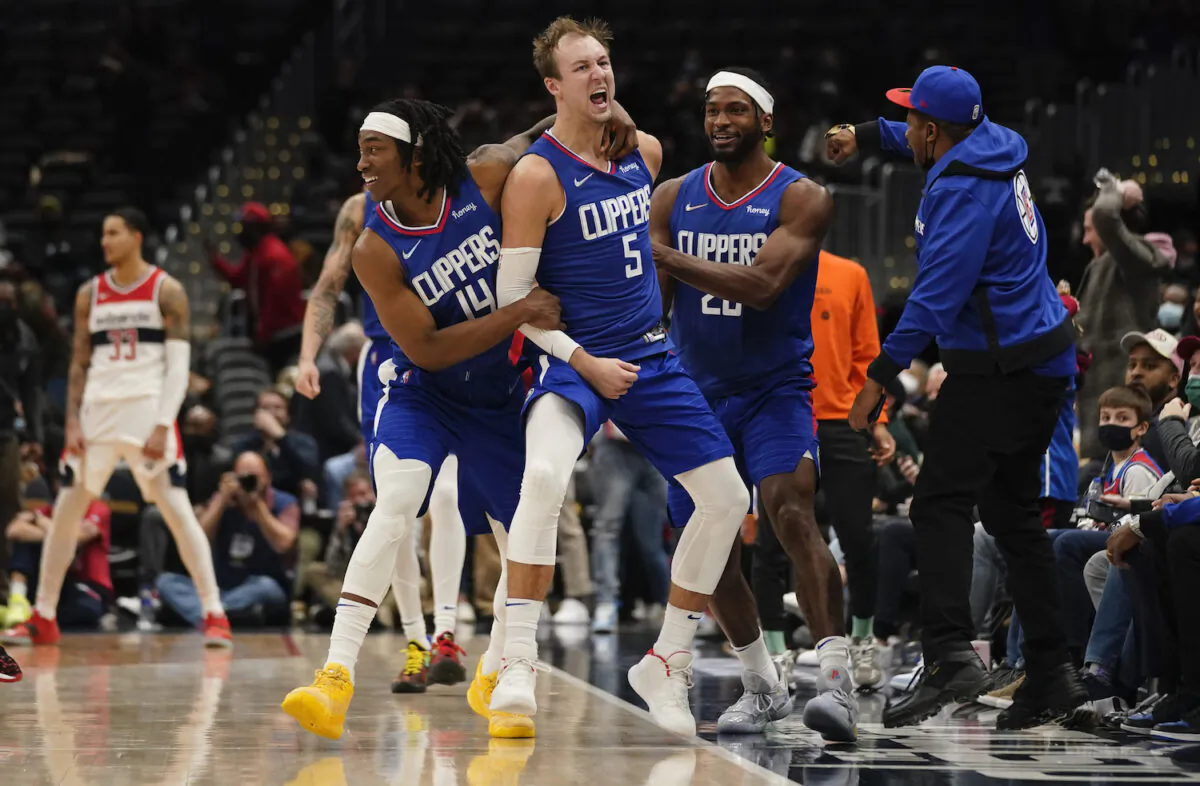 Los Angeles Clippers guard Luke Kennard (5) celebrates after hitting the game tying shot against the Washington Wizards during the second half of an NBA basketball game on Washington on Jan. 25, 2022. The Clippers erased a 35 point deficit to defeat the Wizards 116-115. (Evan Vucci/AP Photo)