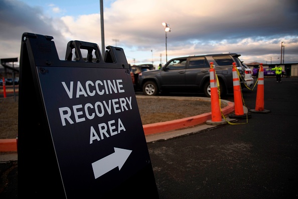 Signage indicates a post vaccination recovery area to monitor for any immediate side-effects as front-line health care workers receive their first shot at a drive up vaccination site from Renown Health on December 17, 2020 in Reno, Nevada.(Photo by PATRICK T. FALLON/AFP via Getty Images)