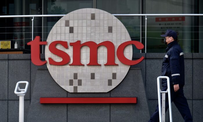A security guard walks past a company logo at the headquarters of the world's largest semiconductor maker TSMC in Hsinchu, Taiwan, on Jan. 29, 2021. (Sam Yeh/AFP via Getty Images)