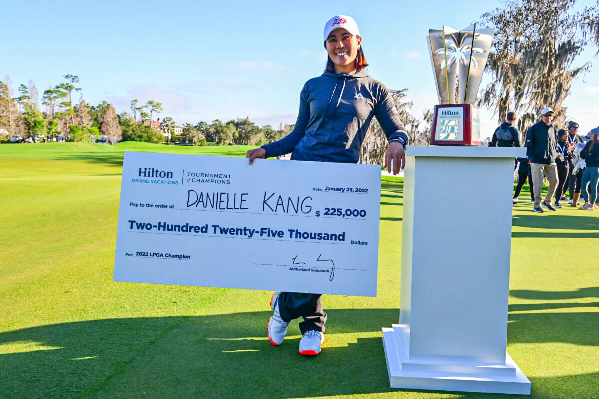 Danielle Kang of the United States poses with the check and trophy after winning the 2022 Hilton Grand Vacations Tournament of Champions at Lake Nona Golf & Country Club, in Orlando, on January 23, 2022. (Julio Aguilar/Getty Images)
