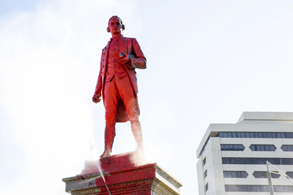 Red paint covers a vandalised statue of Captain James Cook at Catani Gardens in St Kilda  in Melbourne, Australia, on Jan. 26, 2022. (Diego Fedele/Getty Images)