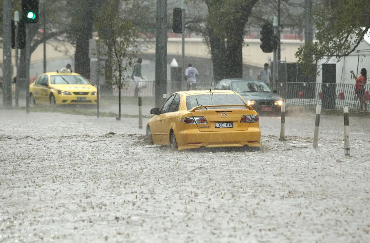 Vehicles attempt to drive through a flooded section of Batman Avenue in Melbourne, Australia, on March 6, 2010. (Robert Cianflone/Getty Images)