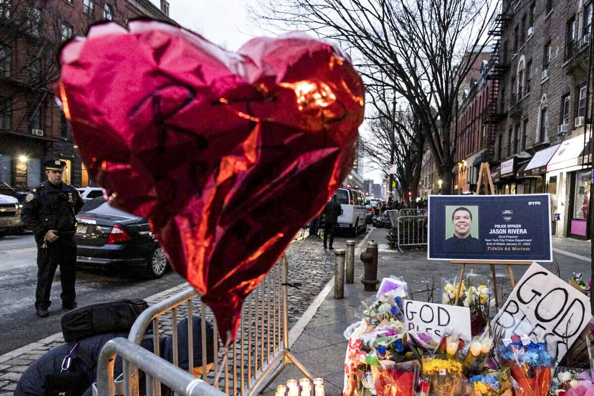 A makeshift memorial is seen outside the New York City Police Department's 32nd Precinct, near the scene of a shooting days earlier in the Harlem neighborhood of New York, on Jan. 24, 2022. (Yuki Iwamura/AP Photo)