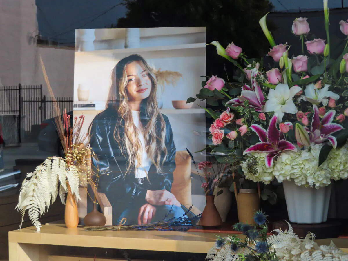 Flowers placed outside Croft House furniture store in memory of graduate student Brianna Kupfer are seen in Los Angeles on Jan. 18, 2022. (Alice Sun/The Epoch Times)