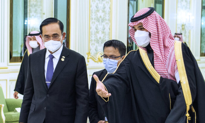 Saudi Crown Prince Mohammed bin Salman, right, welcomes Thai Prime Minister Prayuth Chan-ocha, at the royal palace in Riyadh, Saudi Arabia, on Jan. 25, 2022. (Bandar Aljaloud/Saudi Royal Palace via AP)