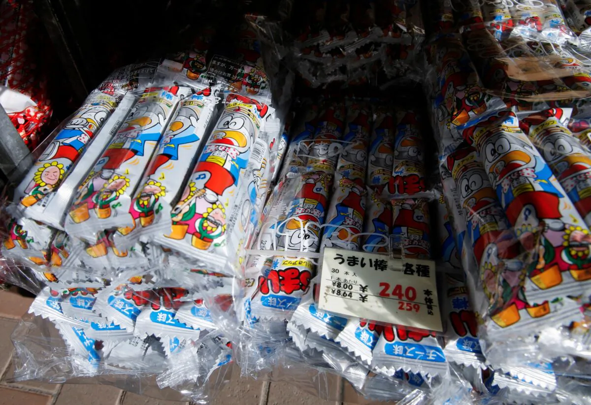 Packs of cheese flavoured version of 'Umaibo', a popular Japanese corn snack, are displayed at a confectionery wholesaler's in Tokyo, on Jan. 25, 2022. (Akira Tomoshige/Reuters)