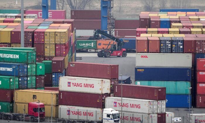 Containers are handled at a logistic port in Duisburg, Germany, on Jan. 25, 2022. (Martin Meissner/AP Photo)