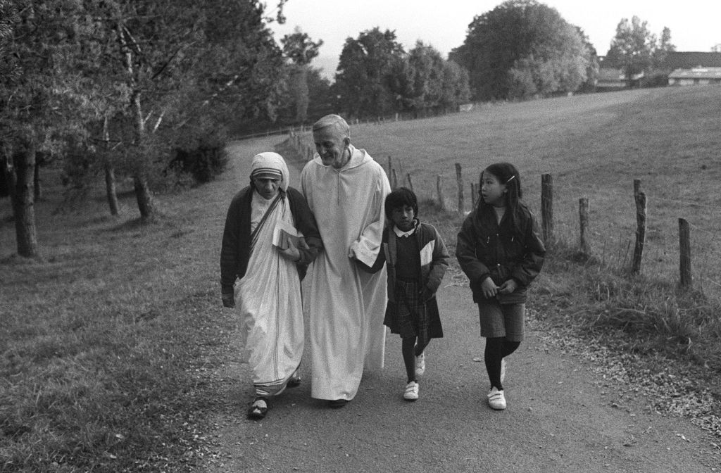 Mother Teresa of Calcutta (L) walks with Roger Schutz-Marsauche, founder and preacher of the community of Taize, during her pilgrimage to Taize on Oct. 23, 1983. (LUC NOVOVITCH/AFP via Getty Images)