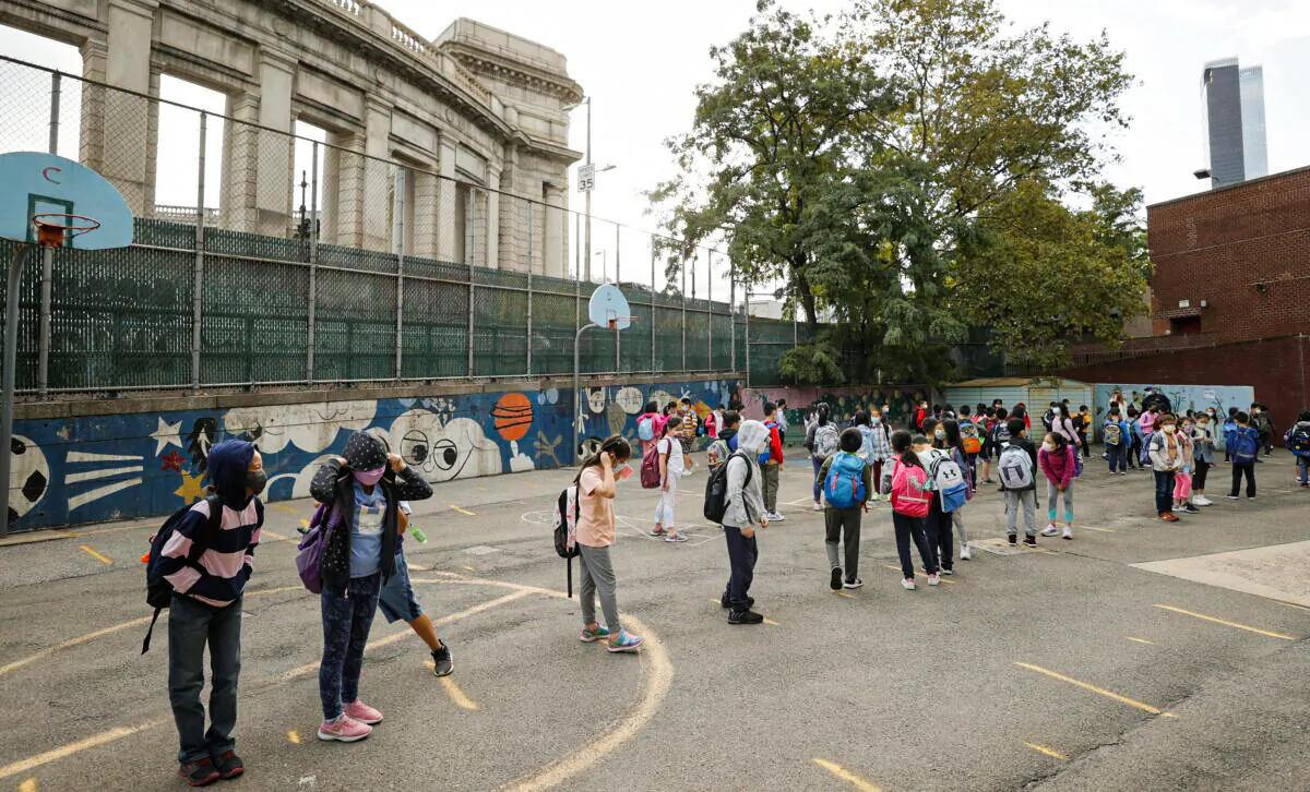 Masked students line up in the morning at Yung Wing School P.S. 124 in New York City on Sept. 27, 2021. (Michael Loccisano/Getty Images)