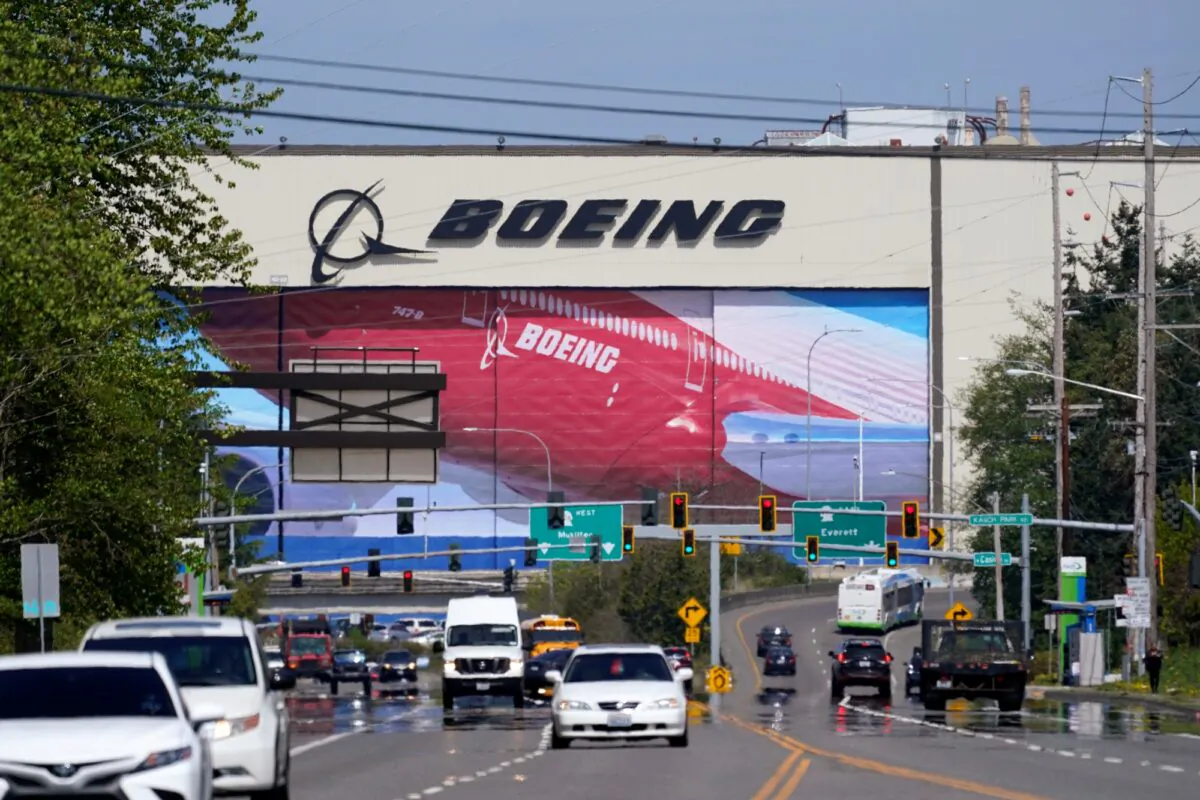 Traffic drives in view of a massive Boeing Co. production plant in Everett, Wash., on April 23, 2021. (Elaine Thompson/AP Photo)