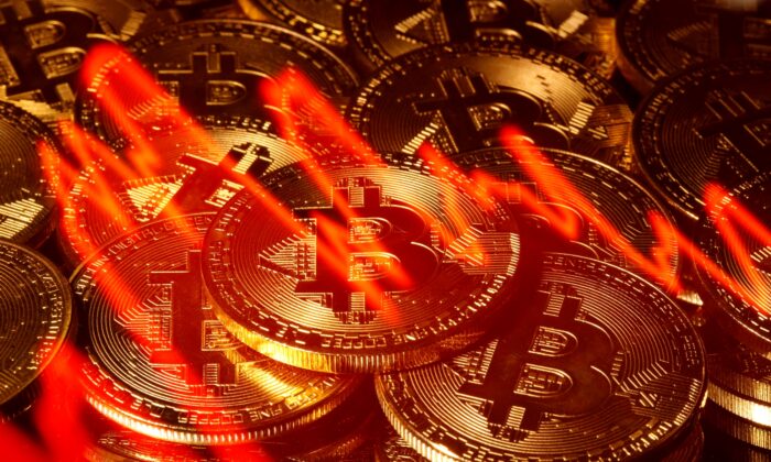 Illumination of the stock graph is seen on the representations of virtual currency Bitcoin in this picture illustration taken on March 13, 2020. (Dado Ruvic/Reuters)