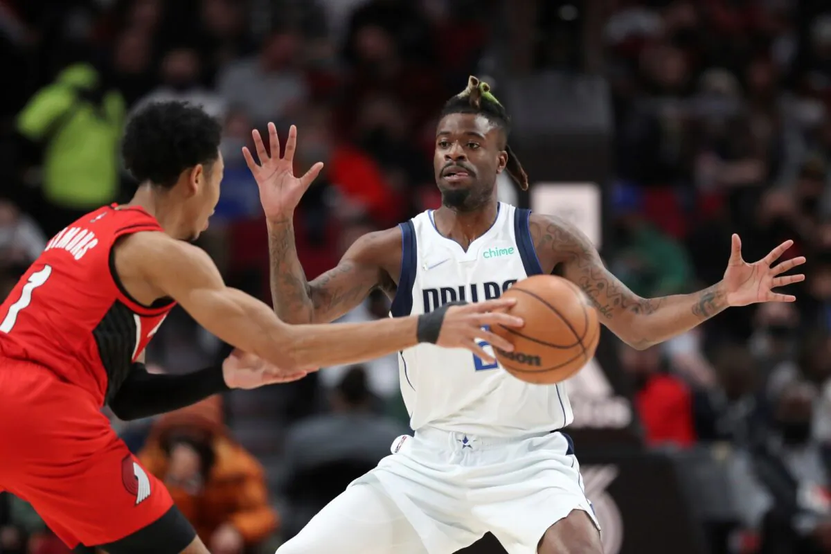 Dallas Mavericks forward Reggie Bullock guards against Portland Trail Blazers guard Anfernee Simons during the first half of an NBA basketball game in Portland, Ore., on Jan. 26, 2022. (Amanda Loman/AP Photo)