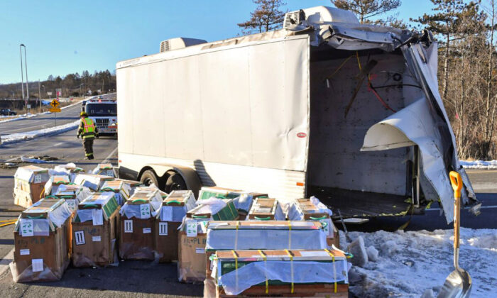 Crates holding live monkeys are collected next to the trailer they were being transported in along state Route 54 at the intersection with Interstate 80 near Danville, Pa., on Jan. 21, 2022. (Jimmy May/Bloomsburg Press Enterprise via AP)