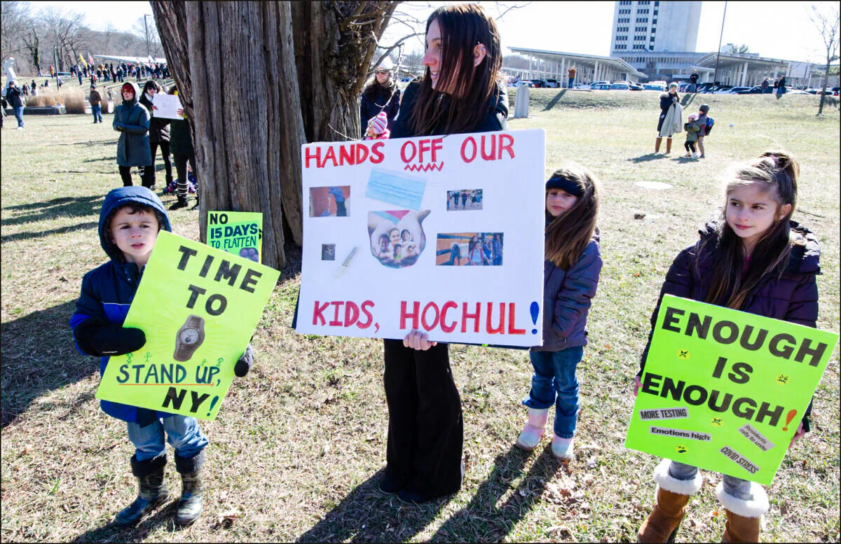 A mother and her children at a Long Island Loud Majority protest against state-mandated masks for school children on January 26, 2022, at the Suffolk County government offices. (Dave Paone/The Epoch Times)