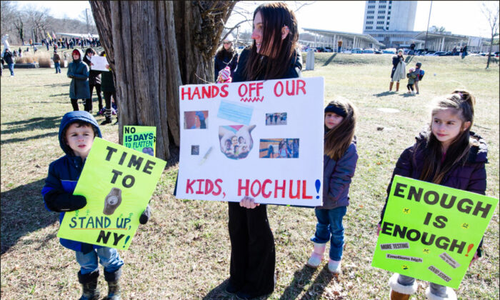 A mother and her children at a Long Island Loud Majority protest against state-mandated masks for school children on January 26, 2022, at the Suffolk County government offices. (Dave Paone/The Epoch Times)