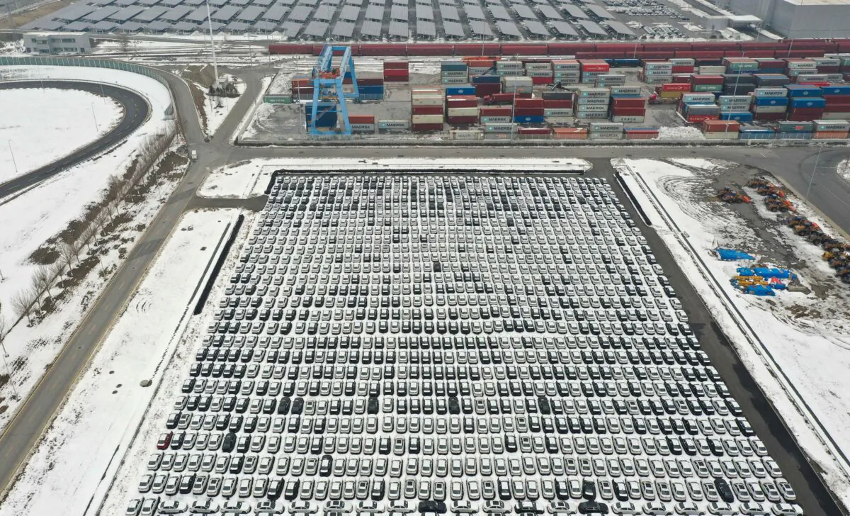 Cars lined up next to shipping containers (top) at a BMW factory in Shenyang in northeastern China's Liaoning Province on Nov. 17, 2021. (STR/AFP via Getty Images)