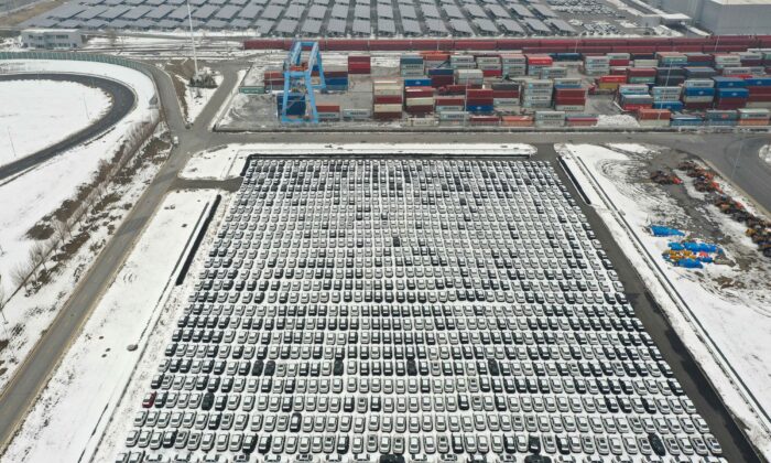 Cars lined up next to shipping containers (top) at a BMW factory in Shenyang in northeastern China's Liaoning Province on Nov. 17, 2021. (STR/AFP via Getty Images)