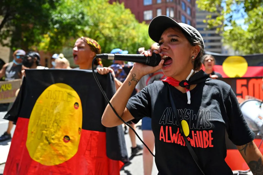 Protesters take part in an "Invasion Day" demonstration on Australia Day in Sydney on January 26, 2022. (Photo by Steven Saphore/AFP via Getty Images)