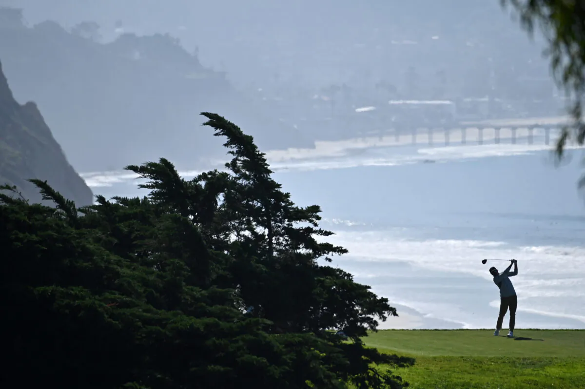 Rickie Fowler hits his tee shot on the 16th hole during the first round of The Farmers Insurance Open on the North Course at Torrey Pines Golf Course, in La Jolla, California, on January 26, 2022. (Donald Miralle/Getty Images)