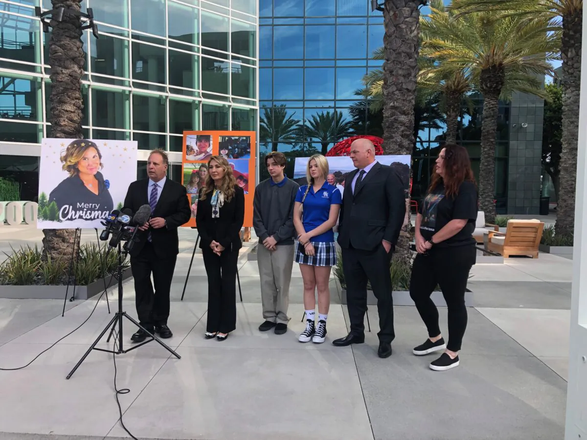 Attorney Eric Dubin (L) and Attorney Anne Della Donna (2nd L), stand with the family and a friend of Nerissa Regnier, who died of COVID-19, during a press conference in Irvine, Calif., on Jan. 26, 2022. (Brandon Drey/The Epoch Times)