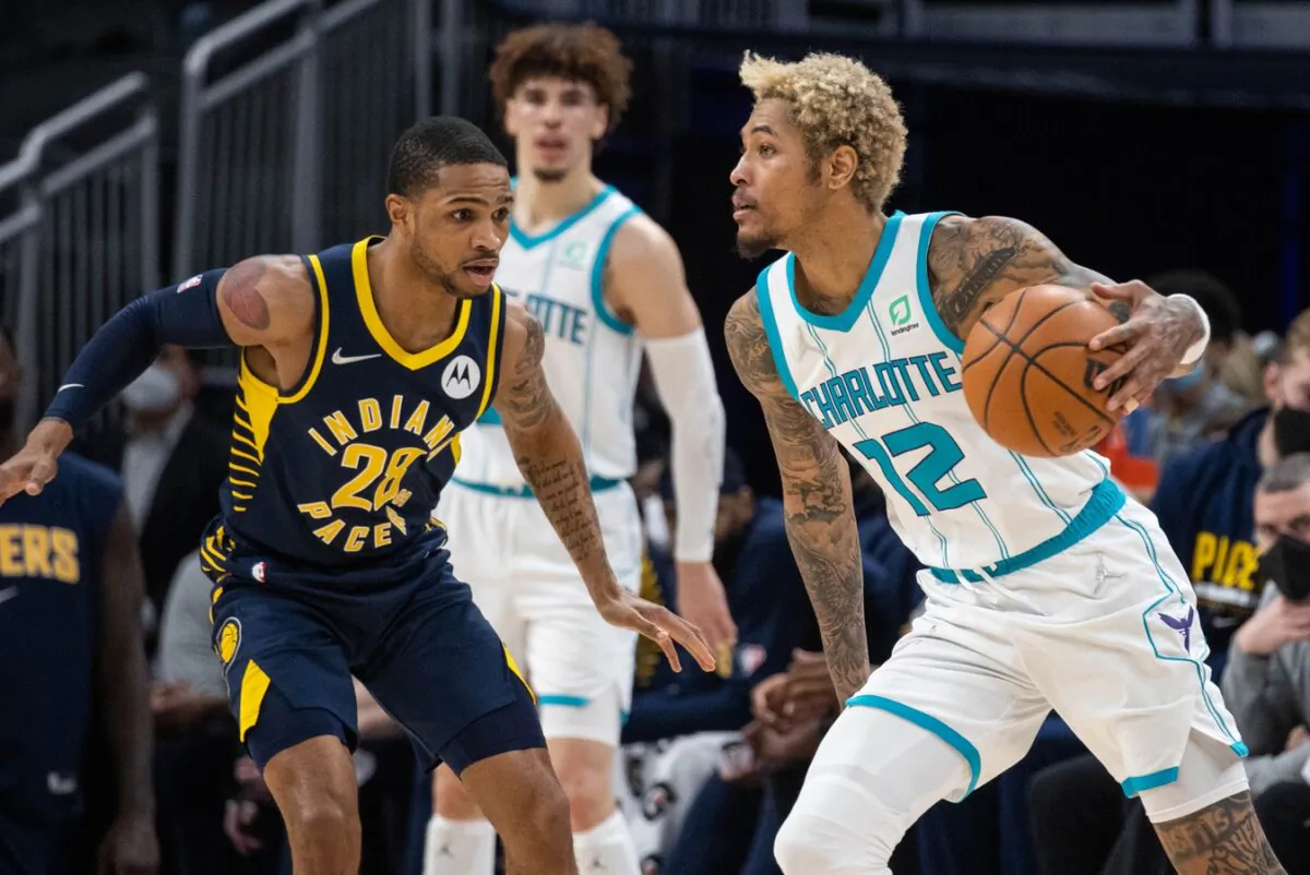 Charlotte Hornets guard Kelly Oubre Jr. (12) dribbles the ball while Indiana Pacers guard Keifer Sykes (28) defends in the second half at Gainbridge Fieldhouse, in Indianapolis, on Jan. 26, 2022. (Trevor Ruszkowski/USA TODAY Sports via Field Level Media)