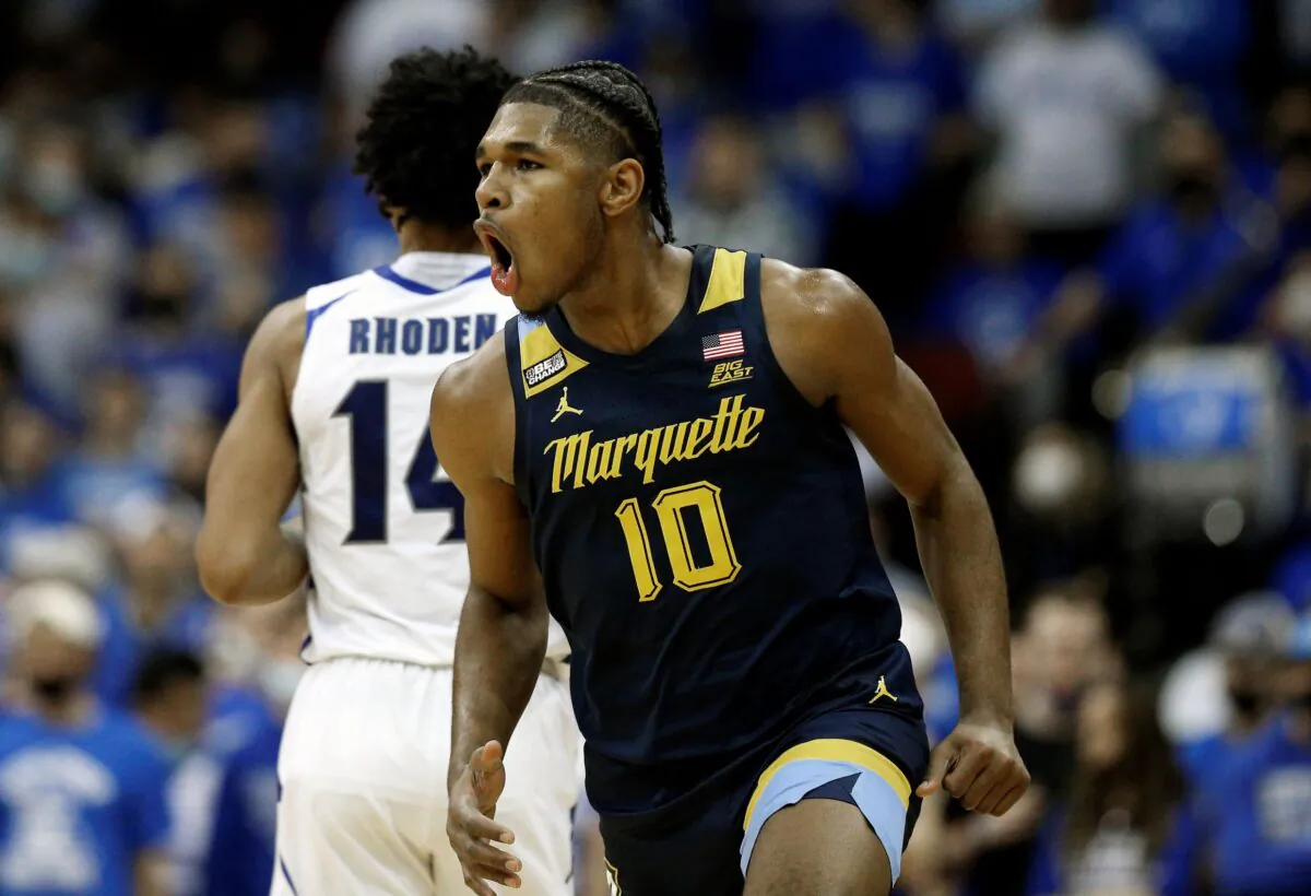 Marquette forward Justin Lewis (10) reacts after making a three-point shot against Seton Hall during the second half of an NCAA college basketball game in Newark, N.J., on Jan. 26, 2022. (Noah K. Murray/AP Photo)