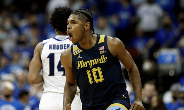 Marquette forward Justin Lewis (10) reacts after making a three-point shot against Seton Hall during the second half of an NCAA college basketball game in Newark, N.J., on Jan. 26, 2022. (Noah K. Murray/AP Photo)