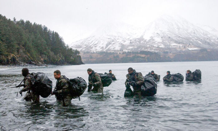 Navy SEALs perform Advanced Cold Weather training to experience the physical stress of the environment and how their equipment will operate, or even sound, in adverse conditions in Kodiak, Alaska on December 14, 2003. (Photo by Photographer's Mate 2nd Class Eric S. Logsdon/U.S. Navy via Getty Images)