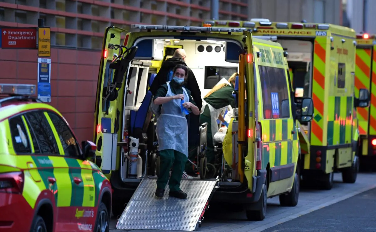 Paramedics work inside an ambulance parked outside the Royal London Hospital in east London on Jan. 7, 2022. (Daniel Leal/AFP via Getty Images)
