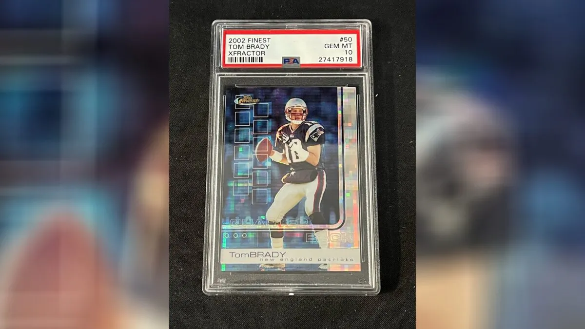 A 2002 Topps Finest X-Fractor card showing football quarterback Tom Brady rests inside a transparent case in Gorham, Maine, on Jan. 19, 2022. (Troy Thibodeau/Saco River Auction LLC via AP)